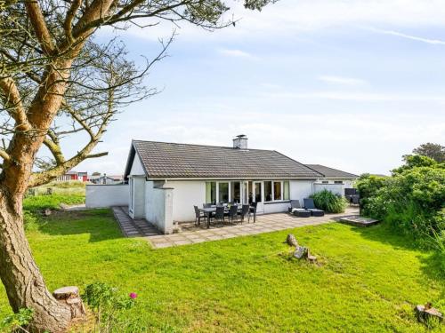 a white cottage with a large grass yard at Holiday Home Kita - 500m from the sea by Interhome in Lakolk