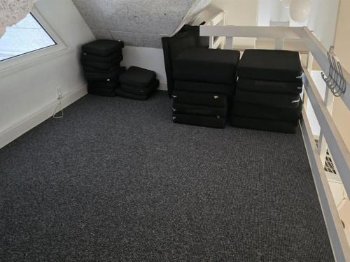 a attic room with a couch and some chairs at Holiday Home Jenna - 1-4km from the sea by Interhome in Vesterhede