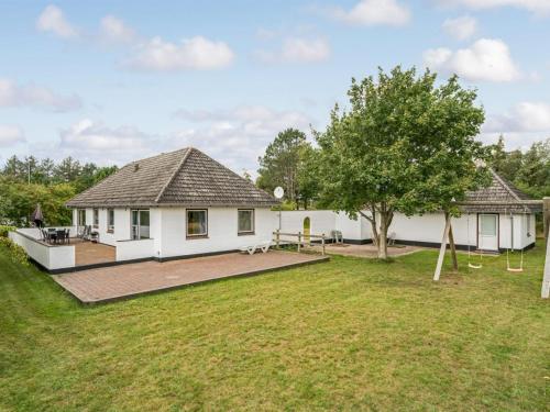 a house with a backyard with a playground at Holiday Home Solmaz - 3-5km from the sea by Interhome in Kongsmark