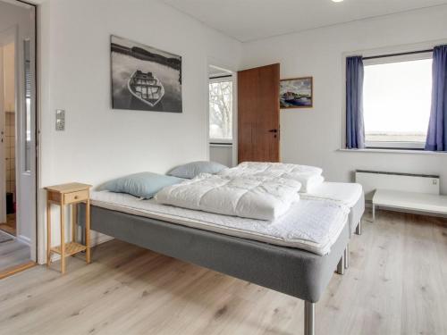 a bedroom with a large bed in a room at Holiday Home Solmaz - 3-5km from the sea by Interhome in Kongsmark