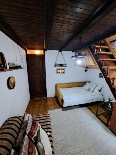 a bedroom with a bed and stairs in a room at Sleep, fly, bye bye in Sarajevo