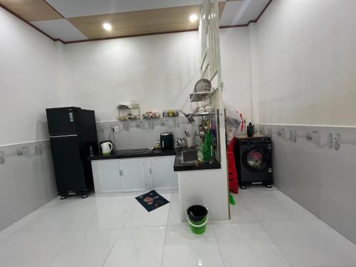 a kitchen with a sink and a stove at The Milla Home Tà Lài-Đồng Nai in Tân Phú