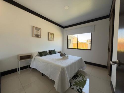 a bedroom with a bed and a window at Fully Equipped 3 beds 2 cars 20-min airport in La Puebla