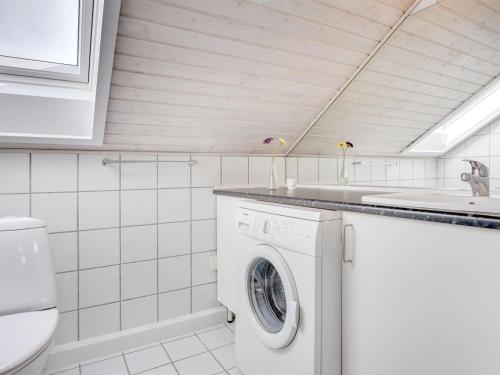 a laundry room with a washing machine and a sink at Apartment Helvig - 2-3km from the sea by Interhome in Sønderby