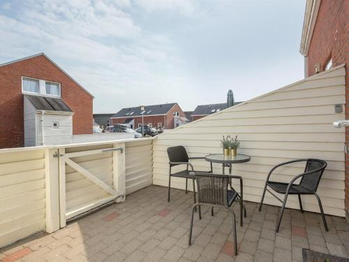 a patio with chairs and a table on a building at Apartment Helvig - 2-3km from the sea by Interhome in Sønderby