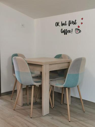 a wooden table with four chairs around it at Peter's apartment - intero appartamento con balcone in Castel SantʼElia