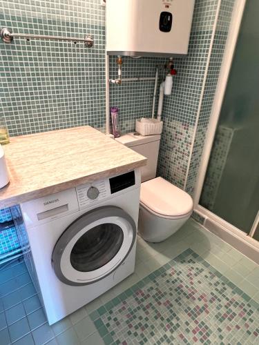 a bathroom with a washing machine and a toilet at French Riviera - Monaco in Beausoleil