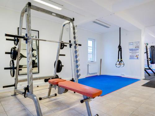 a gym with a weight machine in a room at Apartment Mariam - 2-3km from the sea by Interhome in Sønderby