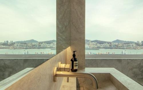 a bottle of wine sitting on a sink in a bathroom at Youngdo Blue Sky 