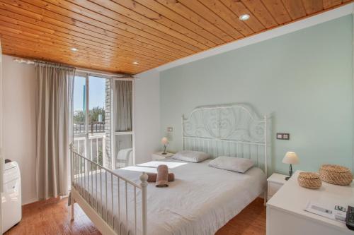a bedroom with a bed with a teddy bear on it at Green Oasis Club in Maspalomas