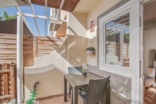 a small table and chair on a patio with stairs at Green Oasis Club in Maspalomas