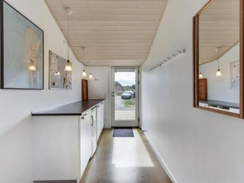 una cucina con pareti bianche e piano di lavoro nero di Holiday Home Lav - 3-8km from the sea by Interhome a Tagholm