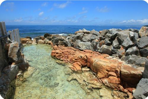 a bunch of rocks in the water near the ocean at B&B Sampark in Shirahama