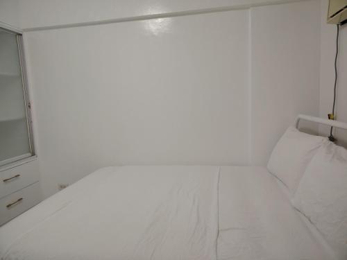 a white room with a bed and a window at Camella Northpoint in Davao City