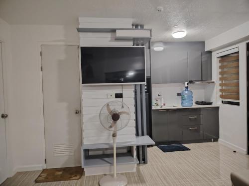 a kitchen with a fan in the middle of a room at Camella Northpoint in Davao City