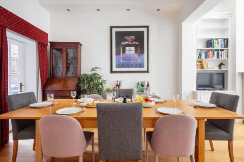 a dining room with a wooden table and chairs at Castle View in Windsor
