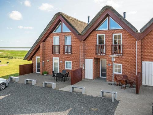a brick house with a patio and a table and chairs at Holiday Home Henrietta - 3-5km from the sea by Interhome in Kongsmark