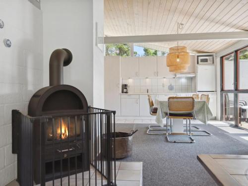 un soggiorno con camino e tavolo di Holiday Home Nila - 750m from the sea by Interhome a Mølby