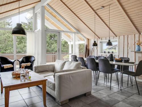 a living room with a couch and a table at Holiday Home Svenny - 800m from the sea by Interhome in Lakolk