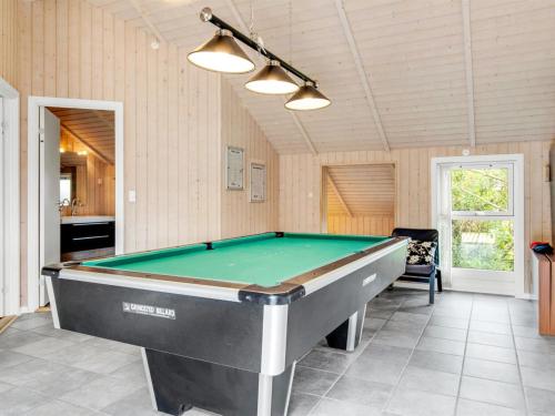 a pool table in the middle of a room at Holiday Home Svenny - 800m from the sea by Interhome in Lakolk