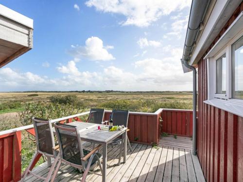 a patio with a table and chairs on a deck at Holiday Home Mortensen - 350m from the sea by Interhome in Lakolk