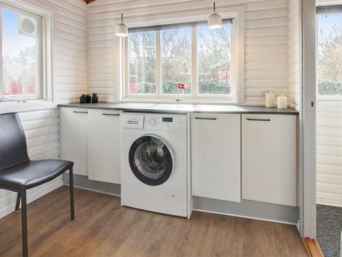 a laundry room with a washer and dryer at Holiday Home Hendrine - 500m from the sea by Interhome in Lakolk