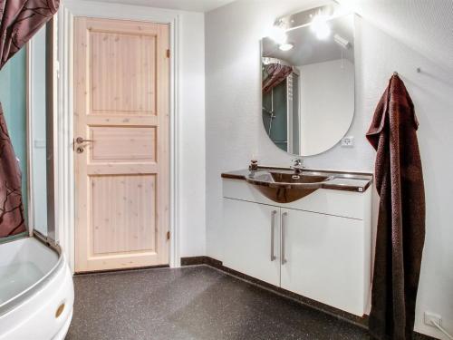 a bathroom with a sink and a mirror at Holiday Home Eda - 3-5km from the sea by Interhome in Kongsmark