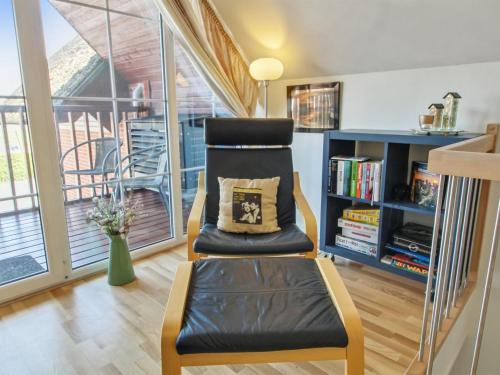 a chair with a pillow on it in a living room at Holiday Home Eda - 3-5km from the sea by Interhome in Kongsmark