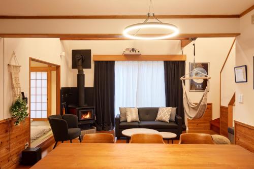 a living room with a couch and a table at Villa Foresta Sora in Nasushiobara