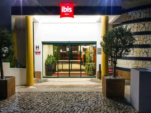 an entrance to a ups building with a sign on it at Hotel ibis Evora in Évora
