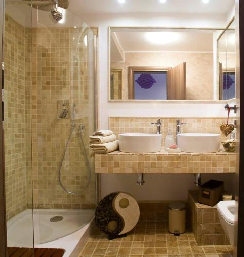 a bathroom with two sinks and a shower and a toilet at Amo Bucharest in Bucharest