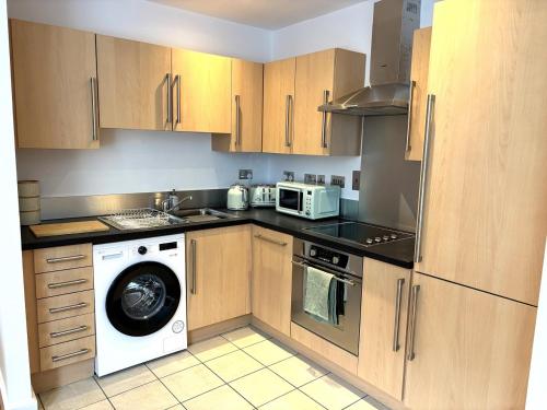 a kitchen with a washing machine and a microwave at 10 Popeshead in York