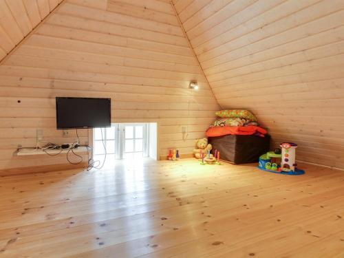 a room with a tv and a couch in a room at Holiday Home Gudmund - 3-9km from the sea by Interhome in Kongsmark