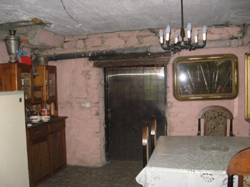 a kitchen with a table and a door in a room at Vilni Kimnaty in Mukacheve