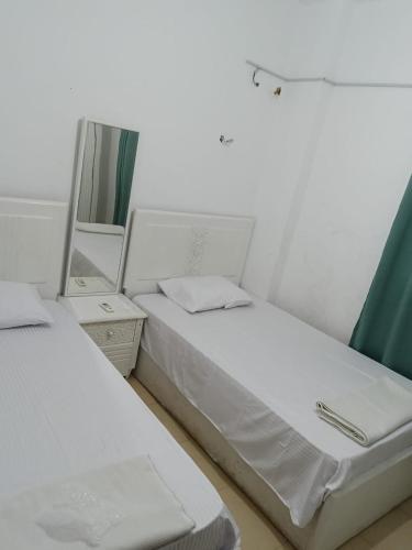 two beds in a room with a mirror at Dahab Hills Resort in Dahab