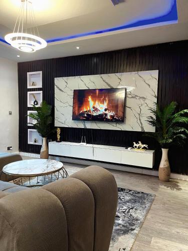 a living room with a fireplace and a couch at ChubyResidence in Lekki