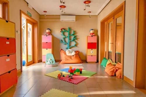 a childs room with colorful furniture and toys on the floor at Anahita Villa Lagoon in Grande Rivière Sud Est