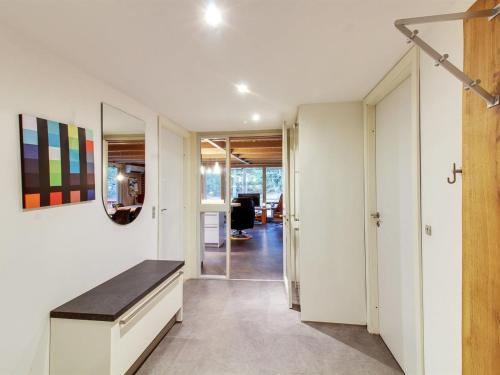 a hallway with white walls and a bench in a room at Holiday Home Nandolf - 3-5km from the sea by Interhome in Bolilmark