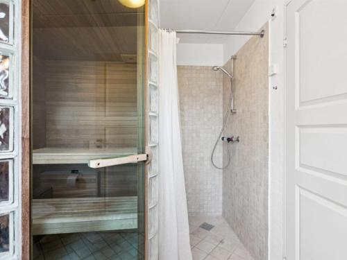 a shower with a glass door in a bathroom at Holiday Home Harriette - 100m from the sea by Interhome in Havneby