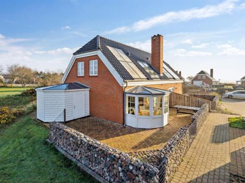 a house with a greenhouse on the roof at Holiday Home Harriette - 100m from the sea by Interhome in Havneby