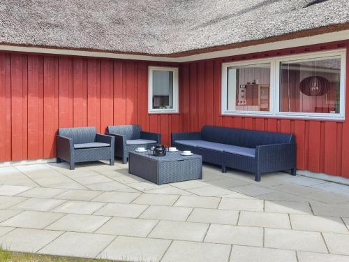 a patio with two couches and a table at Holiday Home Lima - 3-5km from the sea by Interhome in Kongsmark