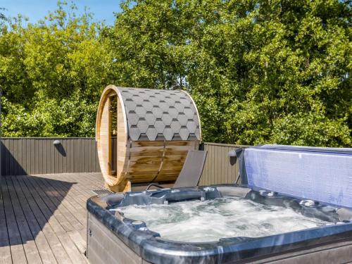 a hot tub on a deck with a gazebo at Holiday Home Jonna - 700m from the sea by Interhome in Lakolk