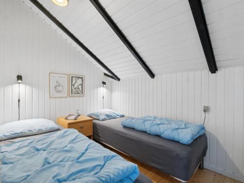 two beds in a room with white walls at Holiday Home Torbjörn - 1-1km from the sea by Interhome in Mølby