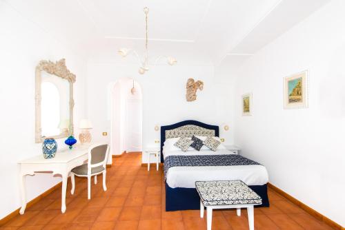 a bedroom with a bed and a table and chairs at La Casa di Peppe in Positano