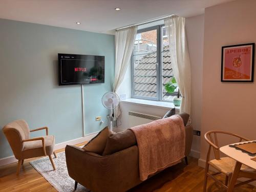 a living room with a couch and a window at 10 Popeshead in York