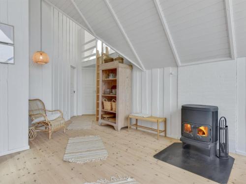 a living room with a wood stove in it at Holiday Home Merta by Interhome in Toftum