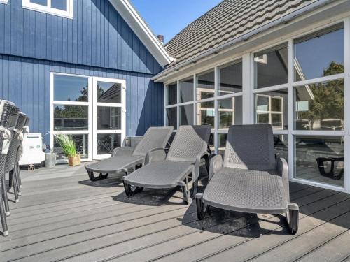 a group of chairs sitting on a deck at Holiday Home Madalena - 2-8km from the sea by Interhome in Toftum