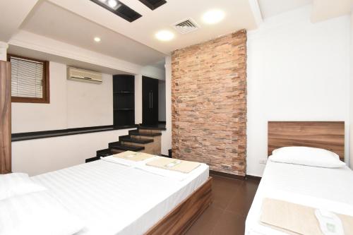 Postel nebo postele na pokoji v ubytování Guset House City