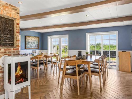 a dining room with a fireplace and a table and chairs at Holiday Home Narvik - 4-5km from the sea by Interhome in Kongsmark