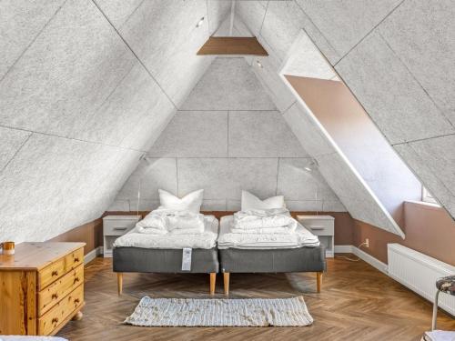 a bedroom with a bed in an attic at Holiday Home Narvik - 4-5km from the sea by Interhome in Kongsmark